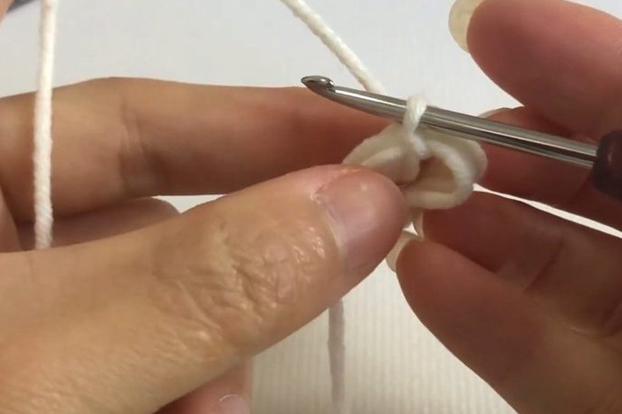 loops slid off the finger to form a ring for a puff stitch crochet snowflake