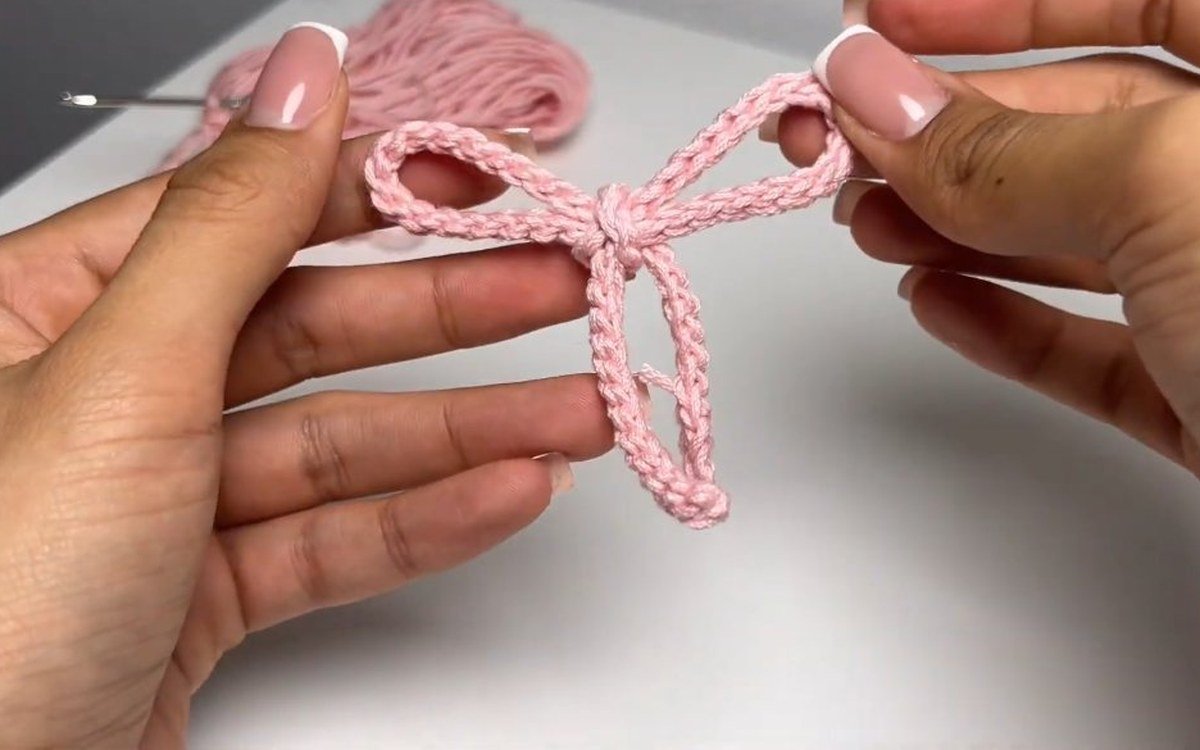 pink bow tied from a slip stitch cord for a crochet cherry keychain