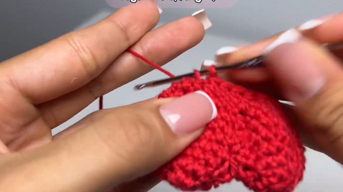 decreasing rounds shaping a heart-shaped crochet cherry keychain cherry