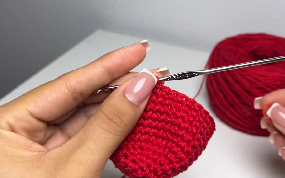 round 13 of a crochet cherry keychain with decreases closing in the bowl