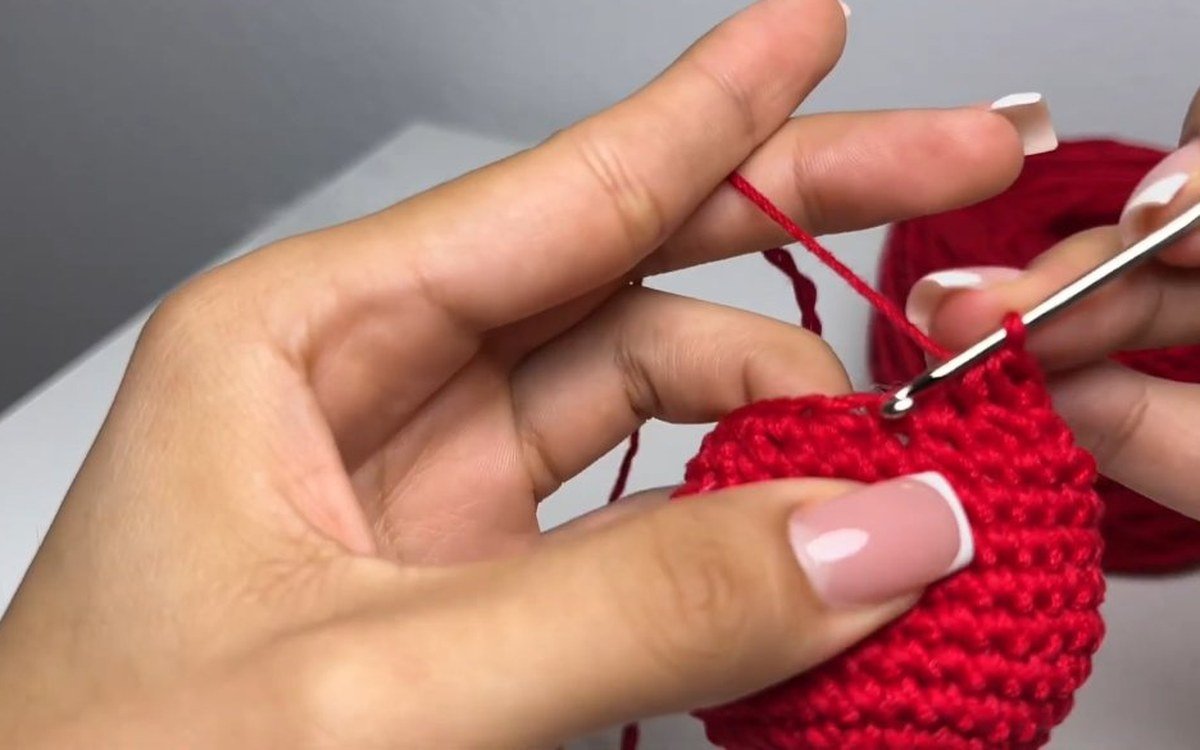 round 14 of a crochet cherry keychain with 12 stitches left