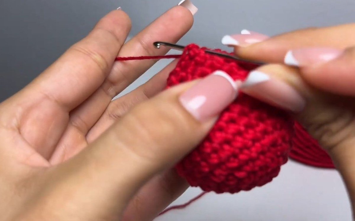 final round of decreases on a crochet cherry keychain cherry