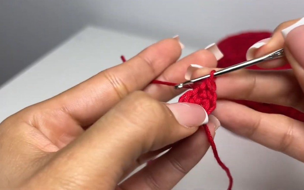 round 2 of a crochet cherry keychain with an increase in every stitch