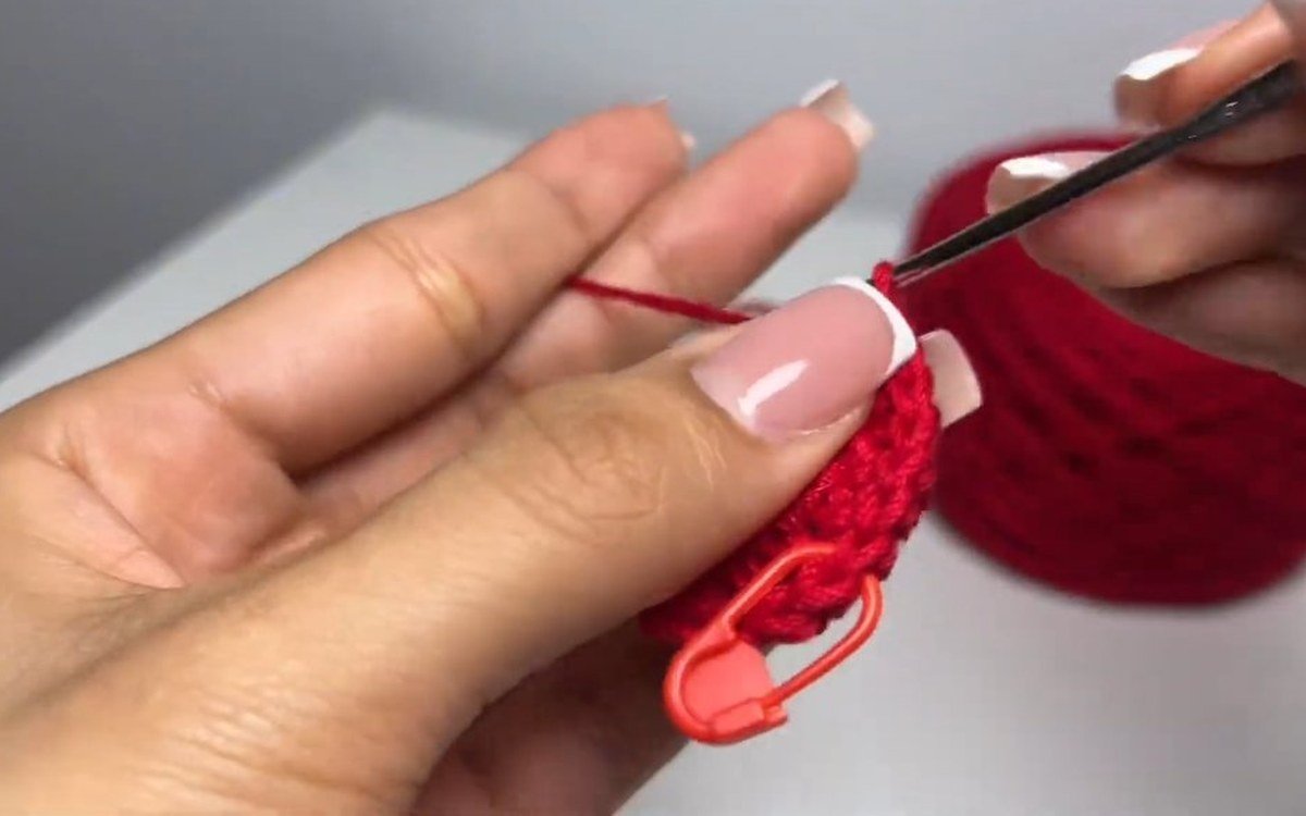 round 4 of a crochet cherry keychain, 24 single crochet worked with the increases offset