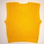 finished yellow granny square vest laid flat, made from this free crochet vest pattern