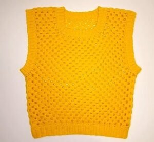 finished yellow granny square vest laid flat, made from this free crochet vest pattern