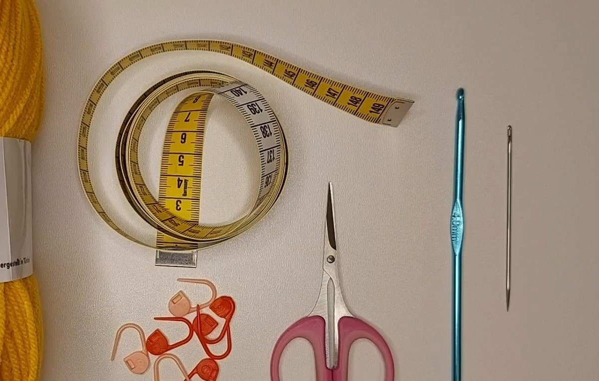 yarn, 4.0 mm crochet hook, scissors, stitch markers, tape measure and needle for a crochet vest pattern