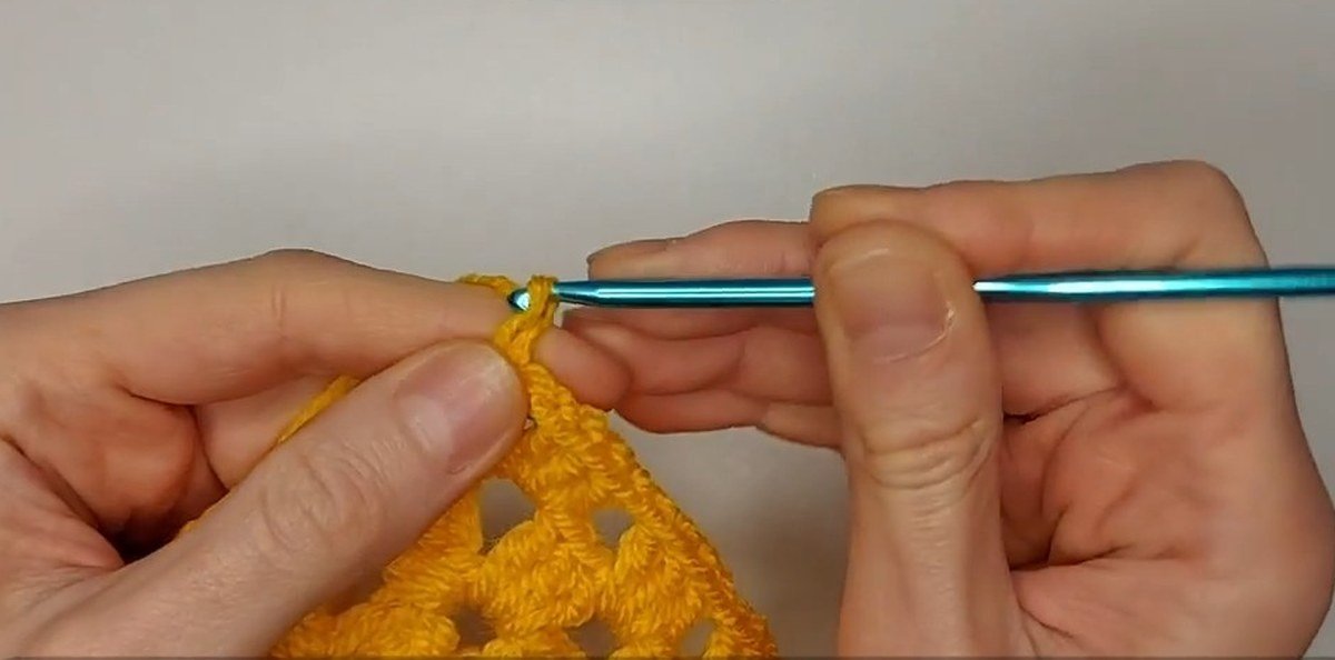 yarn attached in the corner space of the front panel to start a strap for a crochet vest pattern