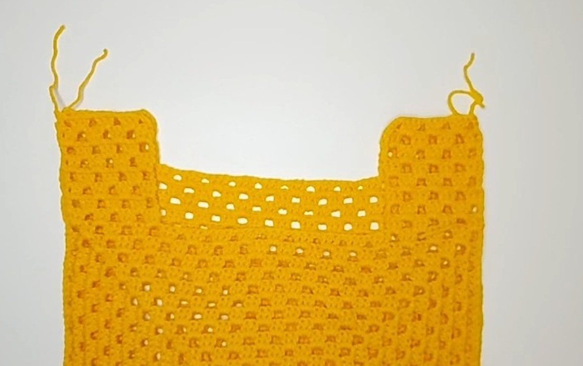 two granny square panels sewn together into a vest shape, crochet vest pattern