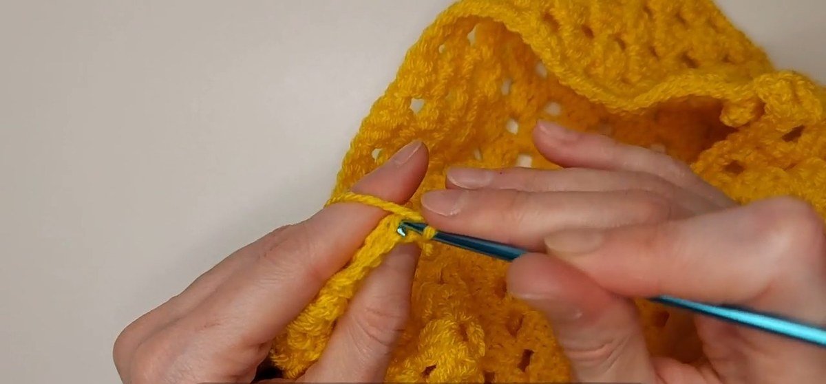ribbing row ending in two slip stitches on the armhole of a crochet vest pattern